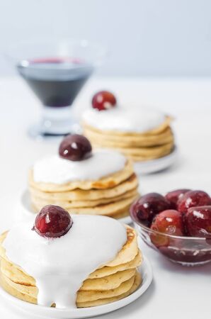 Pancakes with cream and plum jam. Selective focus.の写真素材