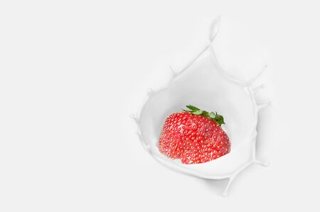 Strawberries fall into the cream with a splash. Selective focusの写真素材