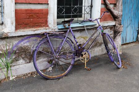 Old repainted Bicycle, on the street next to the houseの写真素材