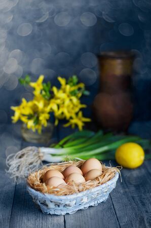Fresh raw eggs in a basket on a bokeh background. Selective focusの写真素材