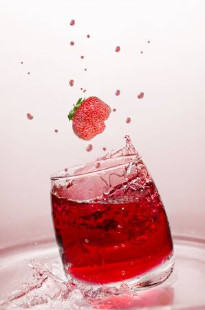 Soft drink with strawberries and splashes, in the summer heat. Selective focusの写真素材