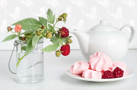 Meringue cookies with fresh raspberries for tea, selective focus