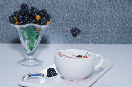 Tea with juicy and ripe fresh blackberries. Selective Focusの写真素材
