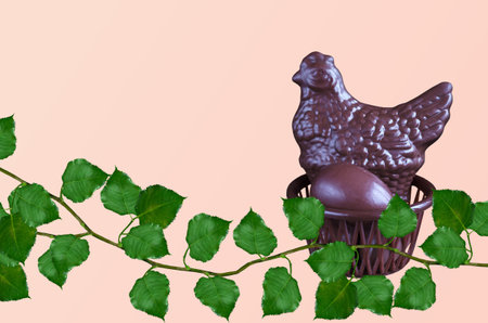 Chocolate chicken and eggs in an Easter basket, on a pink background with green leavesの写真素材
