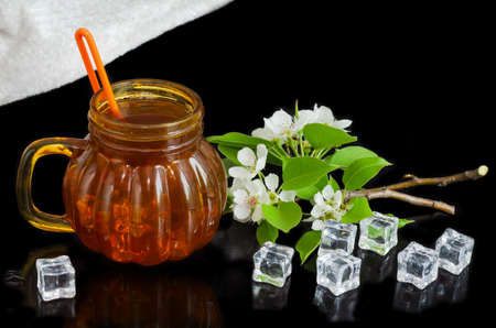 Iced tea with a straw in a jar, black backgroundの写真素材