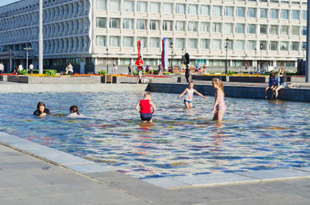 Children frolic in the heat in the citys mosaic fountain. Russia, Ulyanovsk, June 19, 2021のeditorial素材