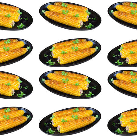 Golden, fried in oil and sprinkled with greens corn on the cob lies on a cast-iron frying pan. Seamless pattern on white background, isolatedの写真素材