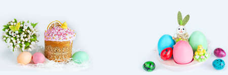Easter widescreen white background with multicolored eggs on a stand with a rabbit, a cake decorated...