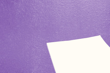 The background is made of an old purple-colored board, with a blank sheet of paper for textの写真素材