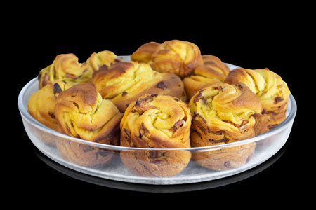 Easter cakes on a glass dish, isolated on a black background. Selective focusの写真素材