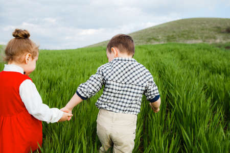 Little children running through the meadow.の写真素材