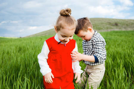 Little children running through the meadow.の写真素材