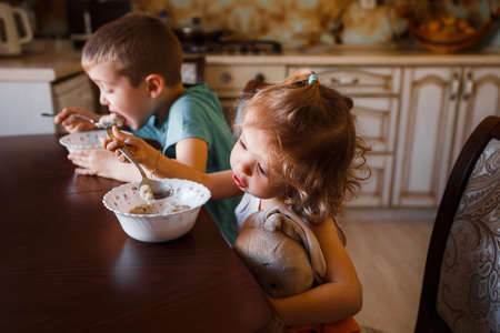 Child eating soup at home. Little girl have a dinnerの写真素材