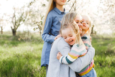 happy family. mother of many children and three daughters child girl summer outdoorsの写真素材