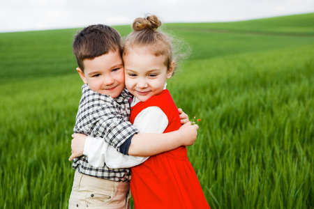 Children in a green field.の写真素材