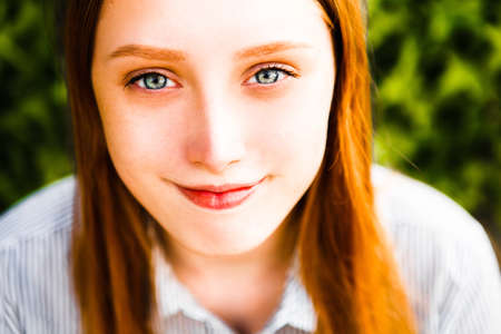 Portrait of red-haired girl close-up.の写真素材
