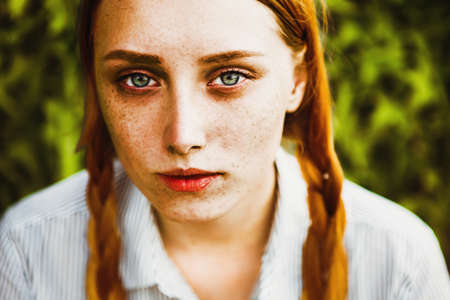 Beautiful red haired irish girl with blu eyes, red hair and lots of frecklesの写真素材