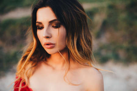 Outdoors portrait of beautiful young brunette woman.の写真素材