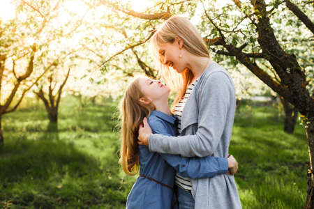 Bright picture of hugging mother and daughterの写真素材