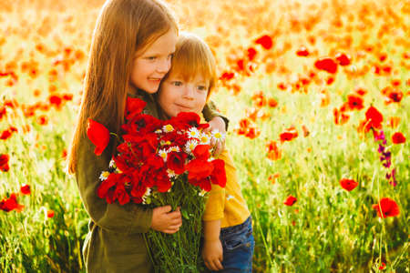 Redheaded children with a red bouquet of flowers.の写真素材