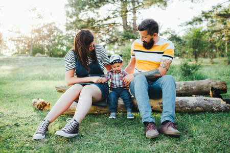 Hipster family, bearded dad with tattoos and stylish clothes.の写真素材