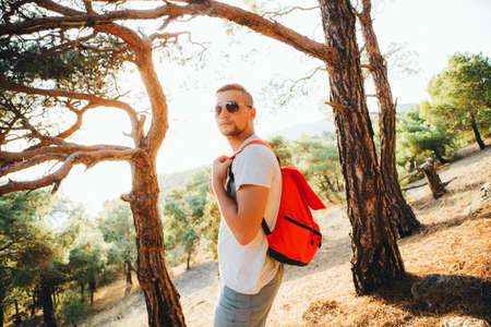 A man is traveling with a light backpack in the mountains.の写真素材