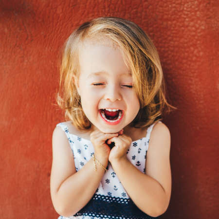 Portrait of an emotional girl on a red background.の写真素材