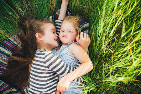 Cute happy children playing in spring filed