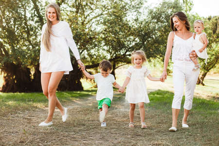A large family with homosexual parents. Two mothers.の写真素材