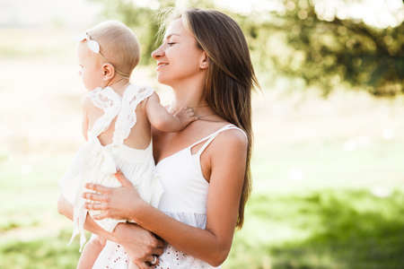 Happy mother and baby walking in cityの写真素材