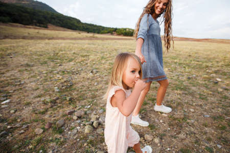 Ð¡urly mother and child are hugging and having fun outdoor in natureの写真素材