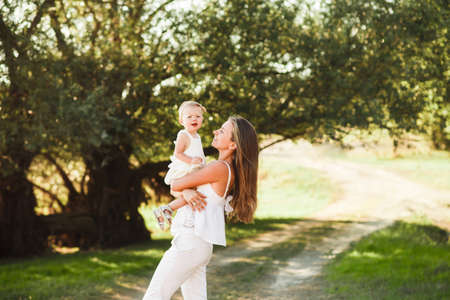 Happy mother and baby walking in cityの写真素材