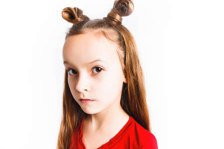 Emotional happy teen girl wearing a red t-shirt and horns shaped hair.の写真素材