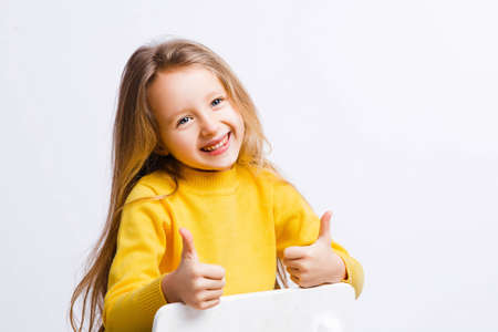 Cute girl 4-5 year old posing in studio. Original, square photo with space for text.