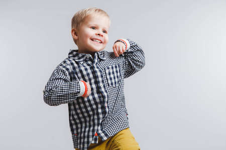 Smiling blond boy in a plaid shirt. White backgroundの写真素材
