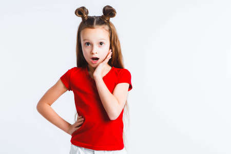 Emotional happy teen girl wearing a red t-shirt and horns shaped hair.の写真素材