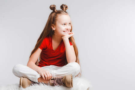 Emotional happy teen girl wearing a red t-shirt and horns shaped hair.の写真素材