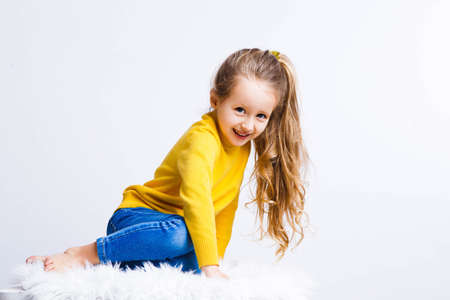 Cute girl 4-5 year old posing in studio. Original, square photo with space for text.の写真素材