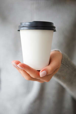 Female hands with a cup of coffee. Close-up.