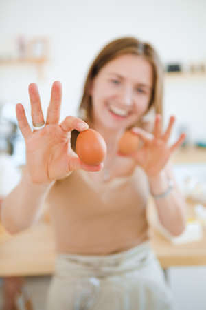 A pastry chef bakes a cake in the home kitchen. Home business.の写真素材