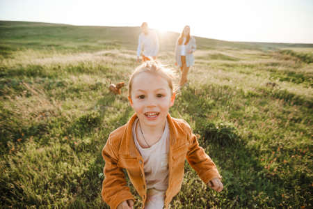 A hipster family walks in a summer field.の写真素材