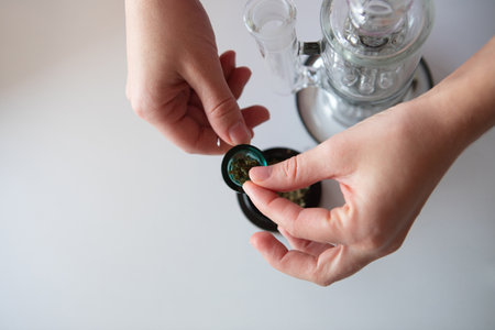 Clear glass bong. Smoking marijuana at home.の写真素材