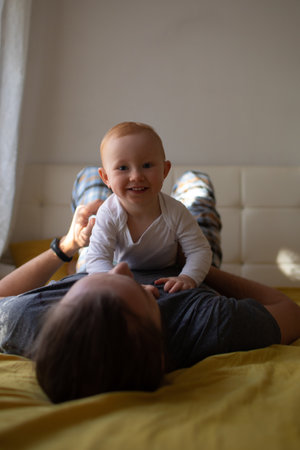Dad and child hug and have fun at home. father's day.の写真素材