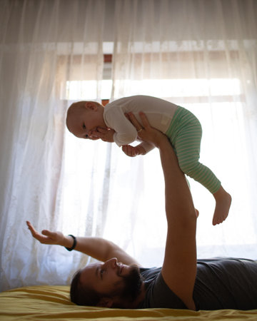 Dad and child hug and have fun at home. father's day.の写真素材