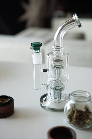 Clear glass bong. Smoking marijuana at home.の写真素材