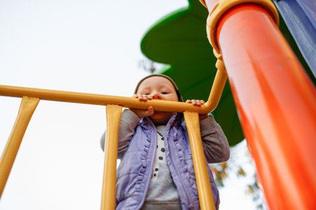 The child plays on the playground. Rides on a swing