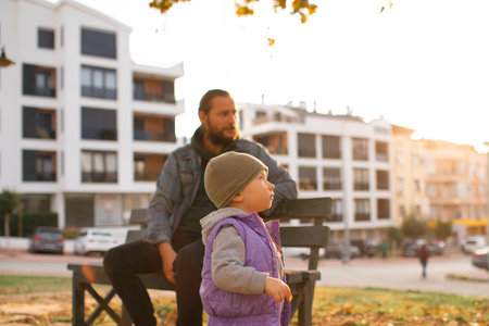 Dad and child are walking in the autumn park. Mediterranean climate.の写真素材
