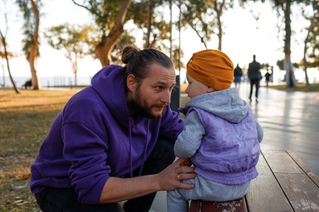 Dad and child are walking in the autumn park. Mediterranean climate.の写真素材