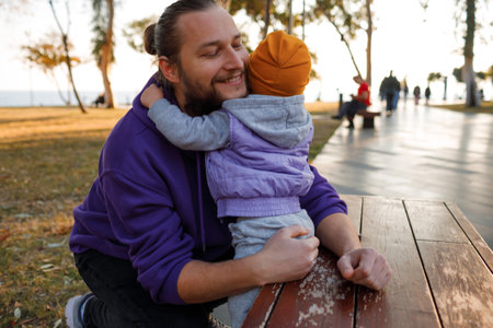 Dad and child are walking in the autumn park. Mediterranean climate.の写真素材