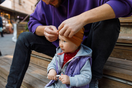 Dad and child are walking in the autumn park. Mediterranean climate.の写真素材